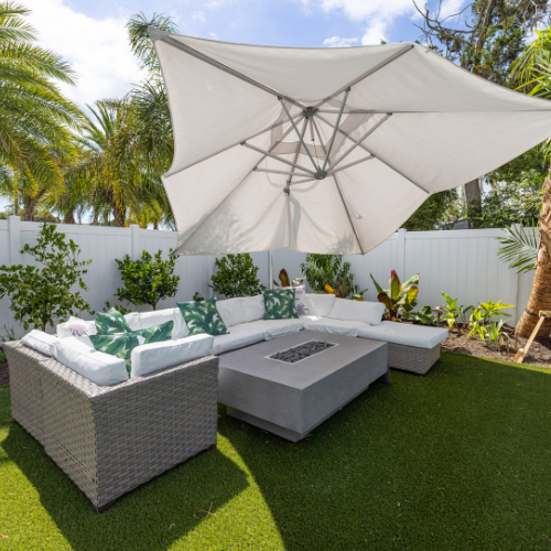Custom swimming pool surrounded by lush landscaping and outdoor seating