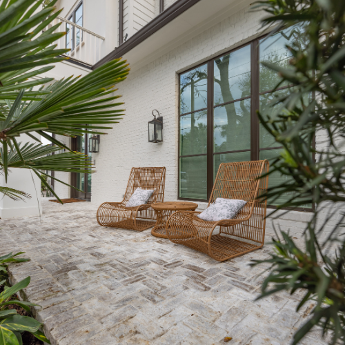 Custom swimming pool surrounded by lush landscaping and outdoor seating